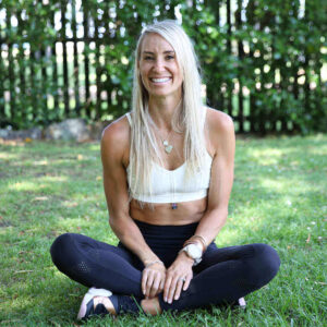 blond girl sitting on the grass danni the figure coach